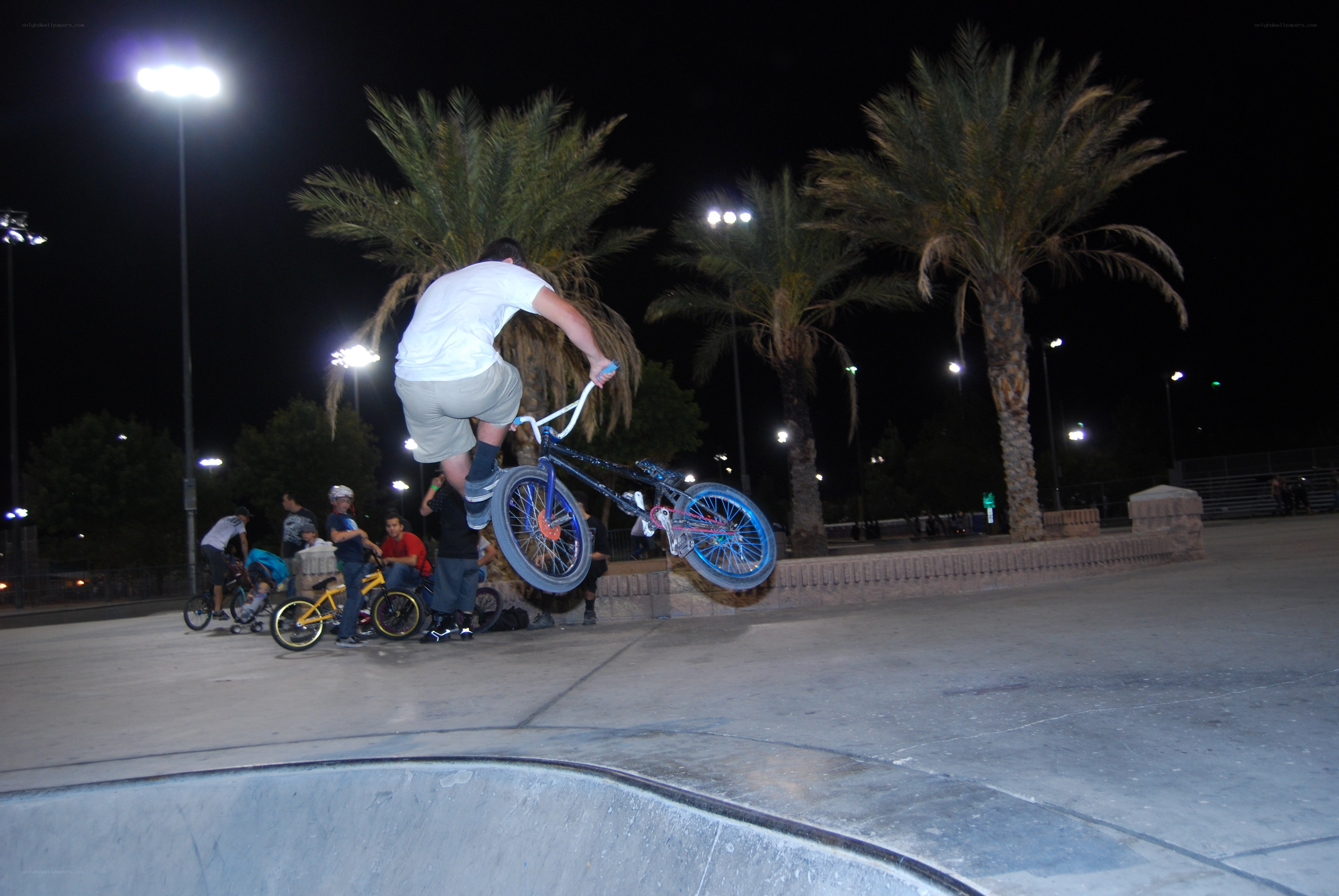 BMX rider performing trick at night
