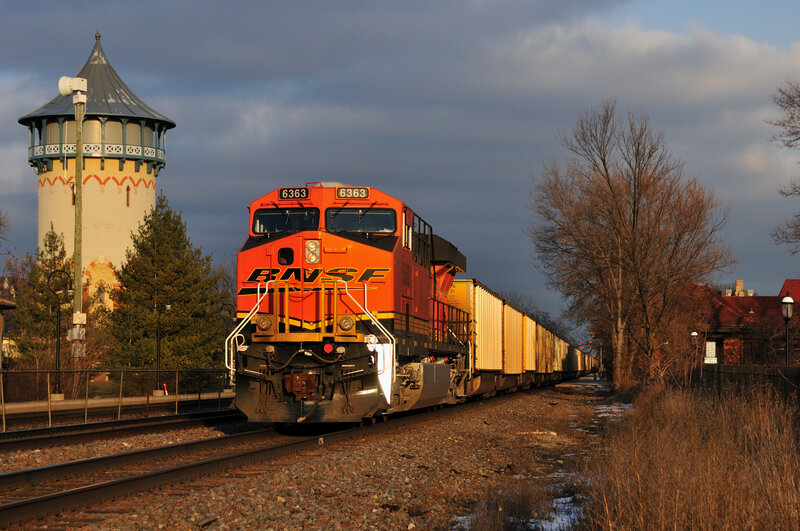 BNSF train passing water tower