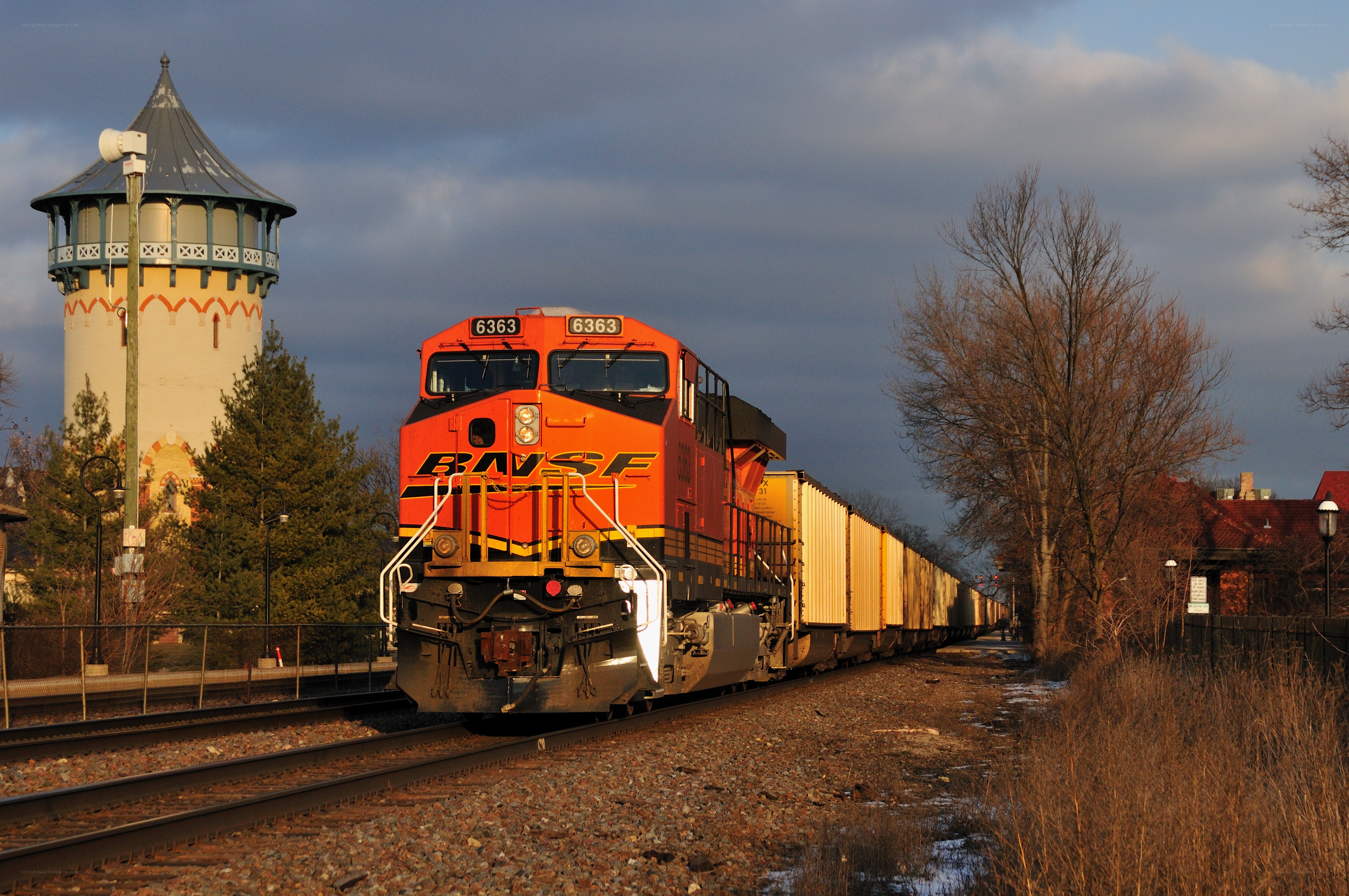 BNSF train passing water tower