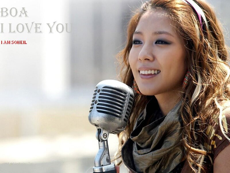 BoA singing into a microphone
