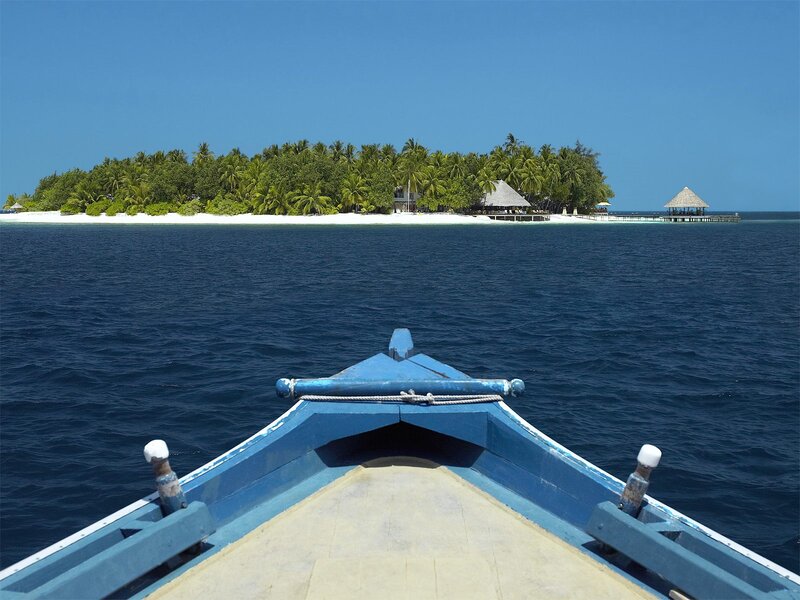 Boat approaching tropical island