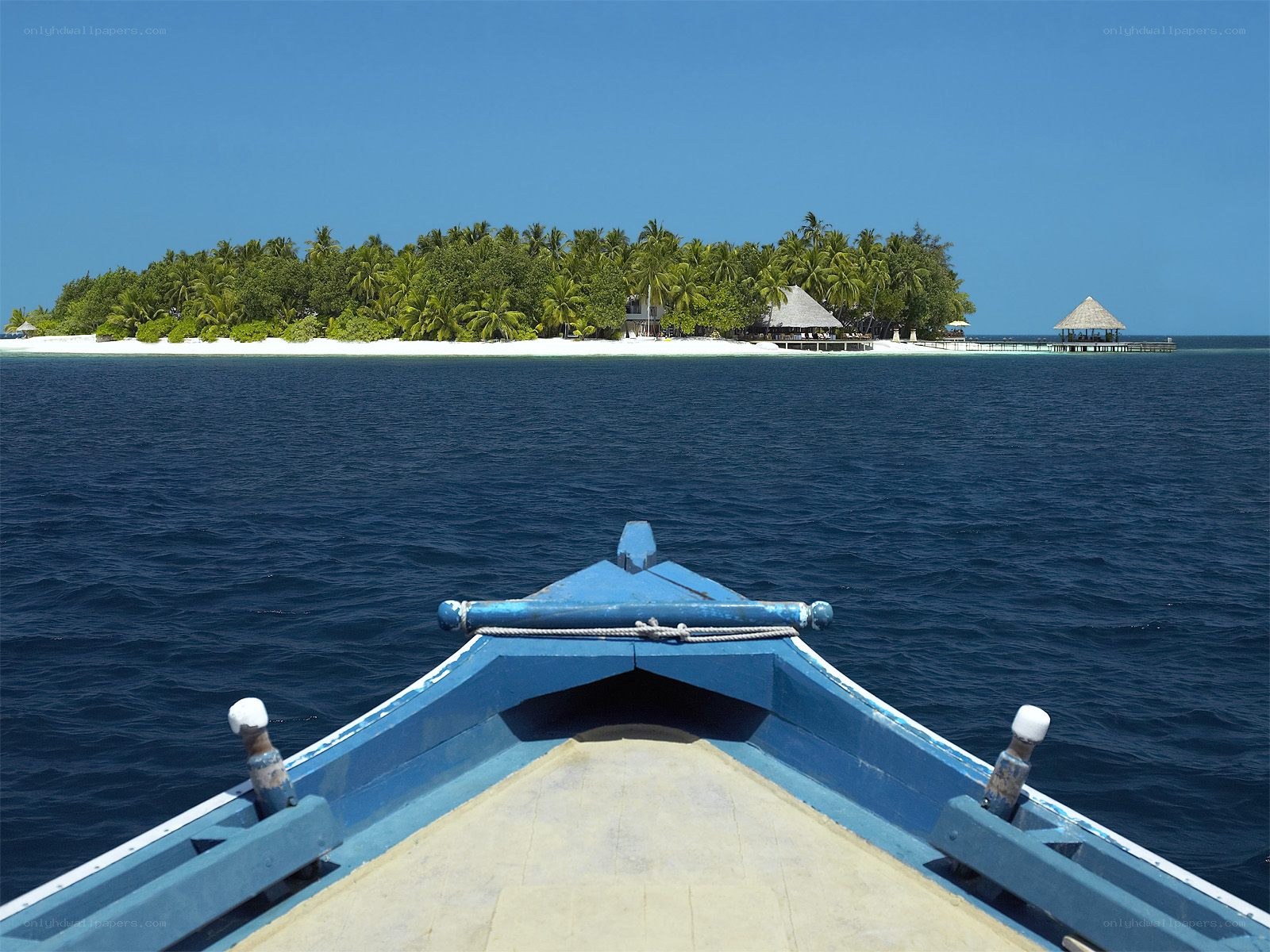 Boat approaching tropical island
