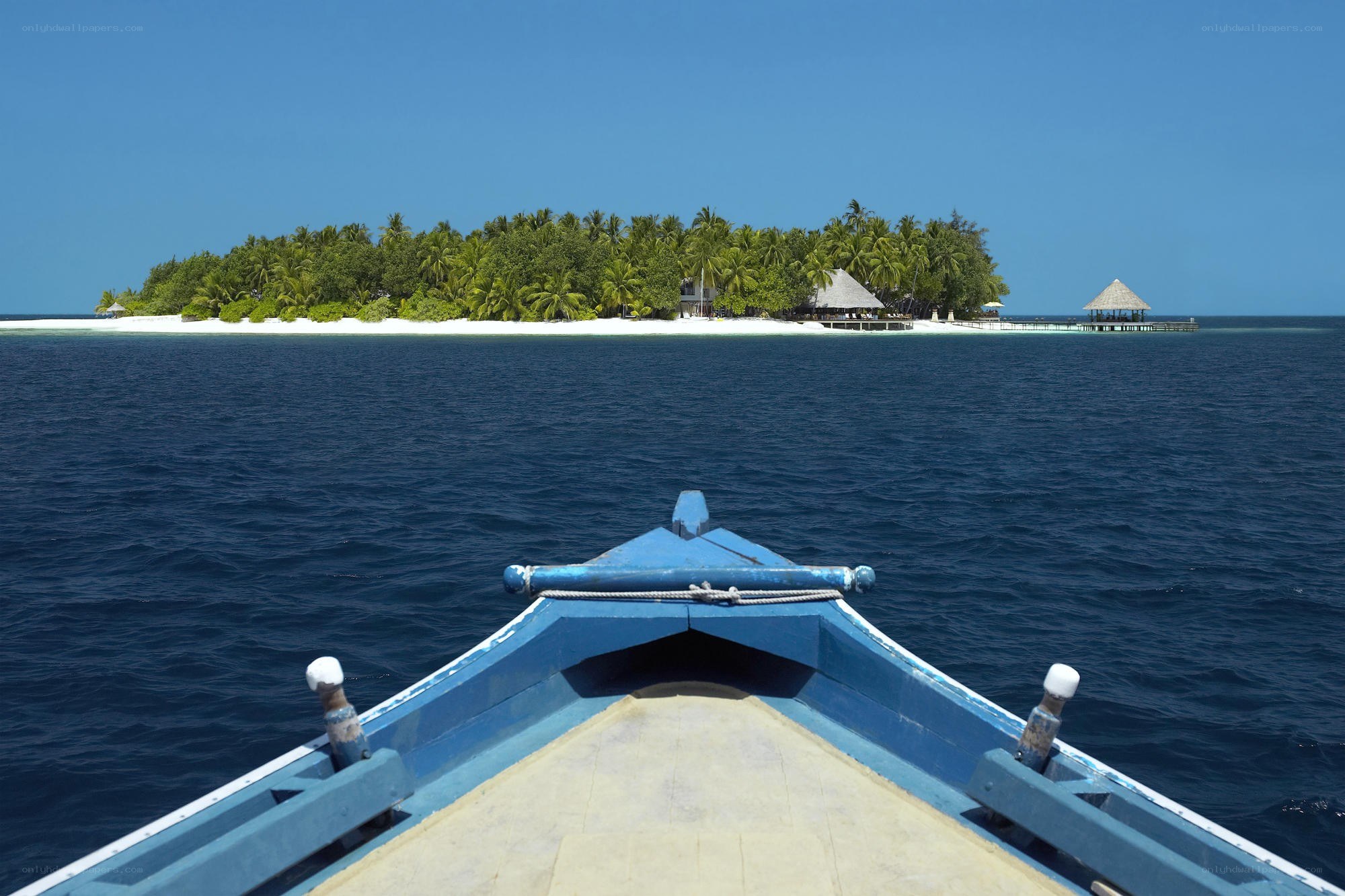 Boat approaching tropical island