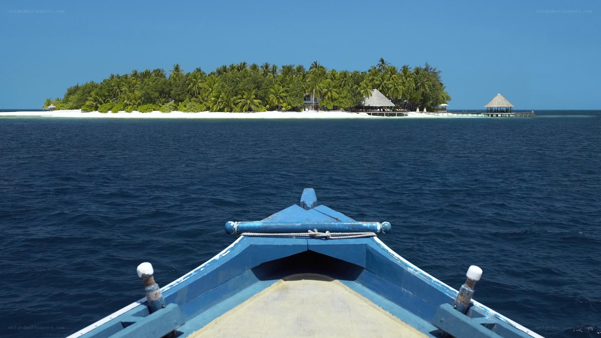 Boat approaching tropical island