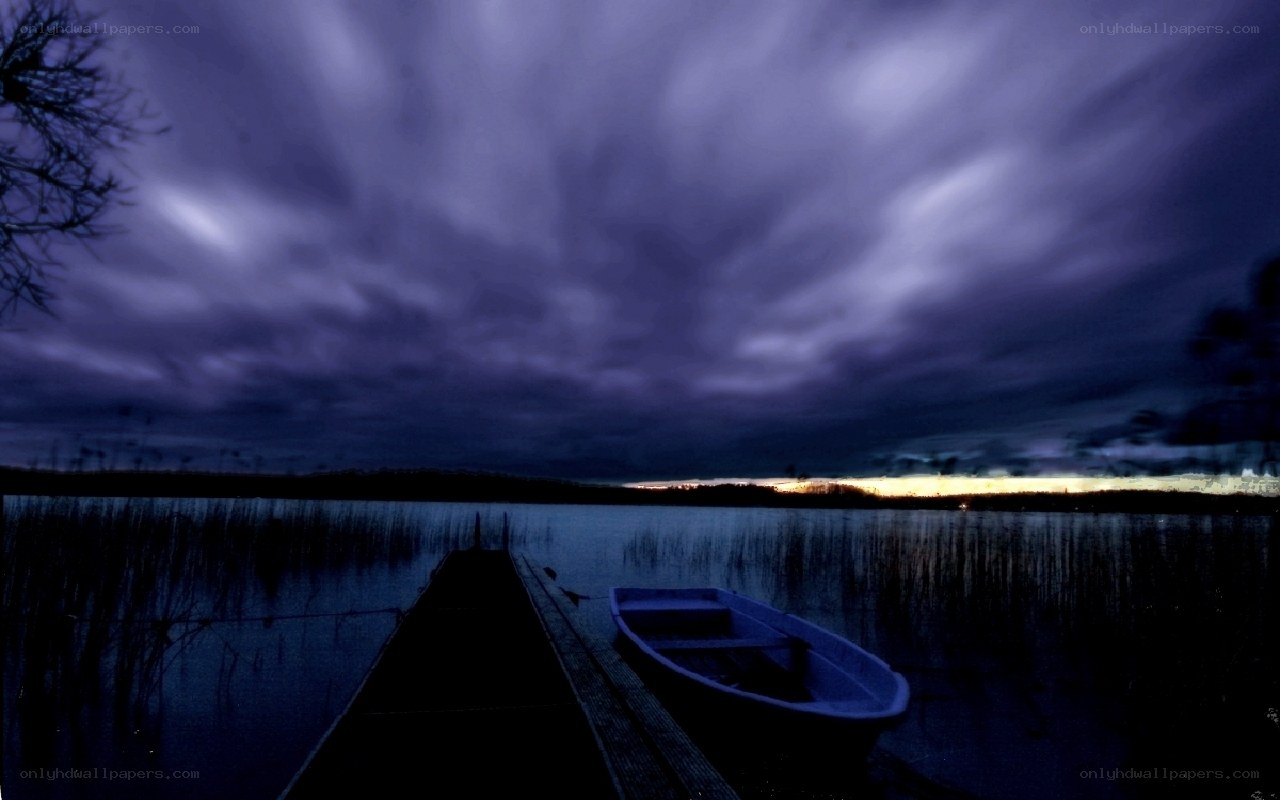 Boat at a dock under stormy sky