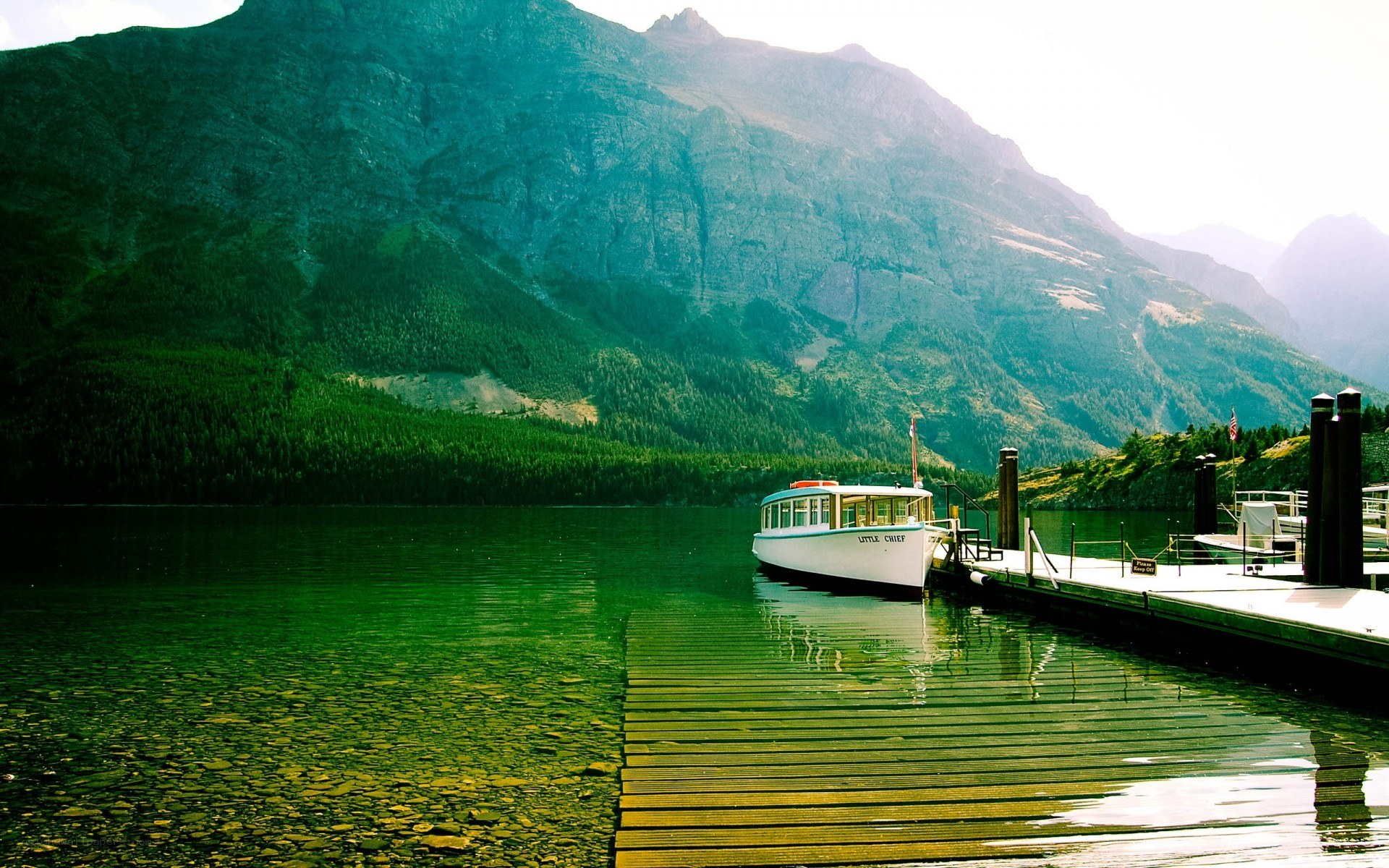Boat at dock by mountain lake