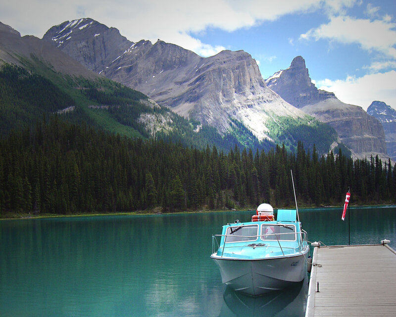 Boat at dock by mountain lake