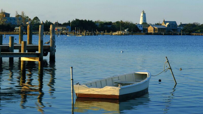 Boat at dock with lighthouse