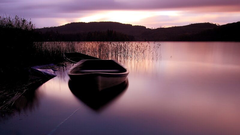 Boat at dusk on a calm lake