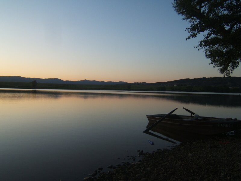 Boat at dusk on a calm lake