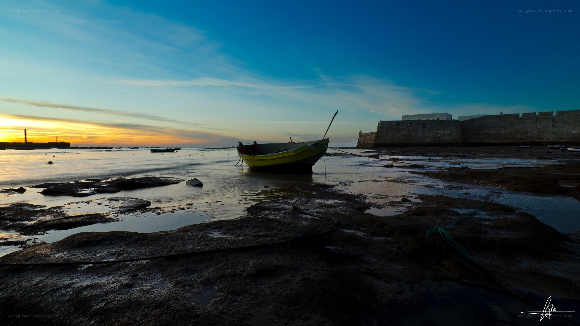 Boat at sunset by the fortress