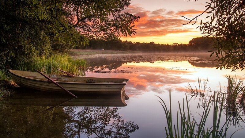 Boat at sunset on a calm lake
