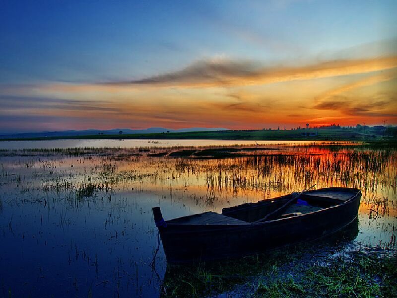 Boat at sunset on a calm lake