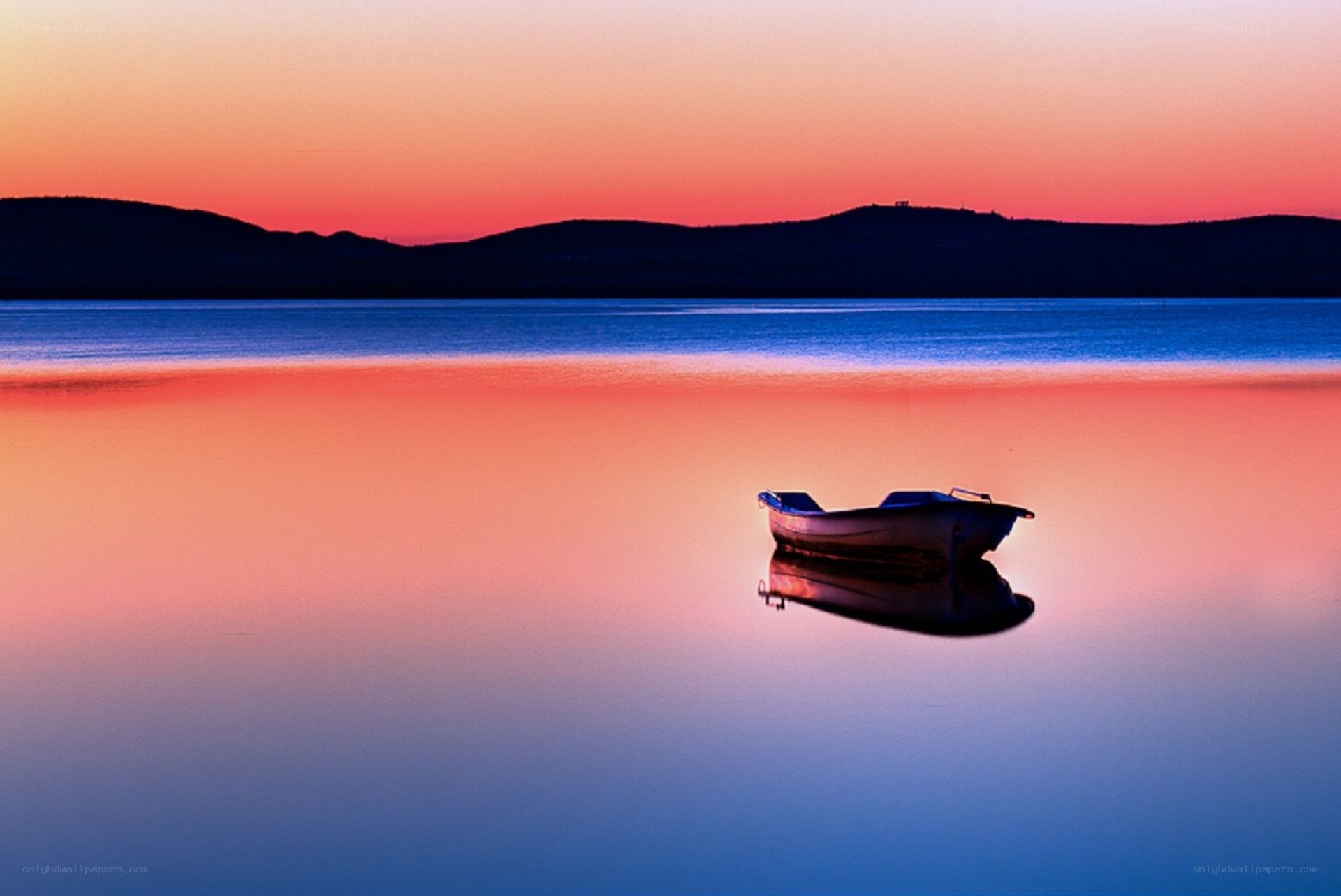 Boat at sunset on calm lake