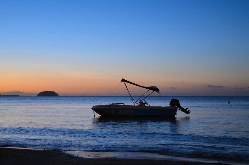Boat at sunset on calm sea