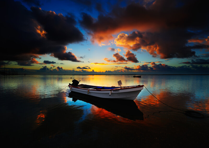 Boat at sunset on calm water