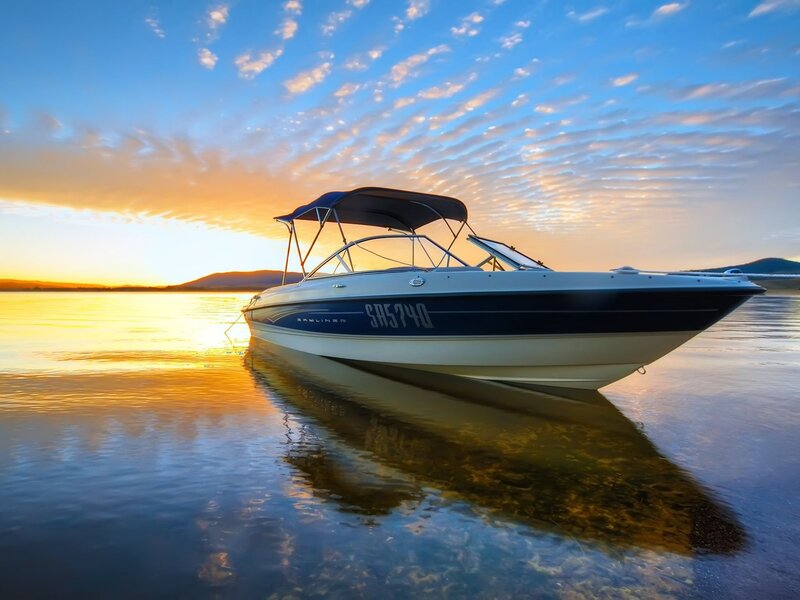 Boat at sunset on calm water