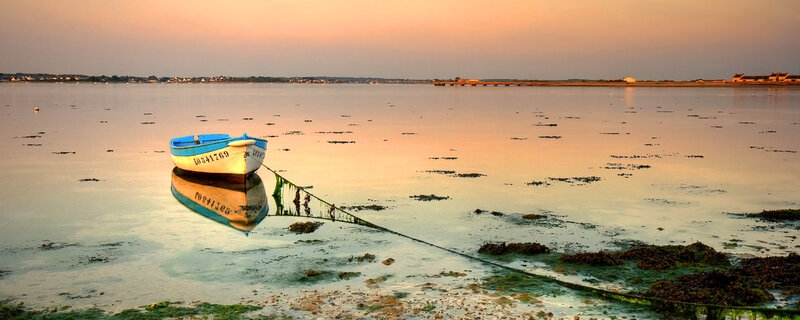 Boat at sunset on calm water