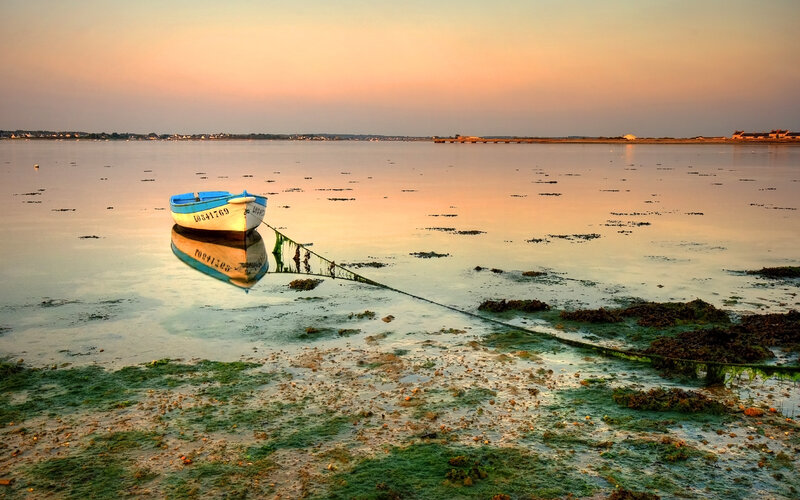 Boat at sunset on calm water