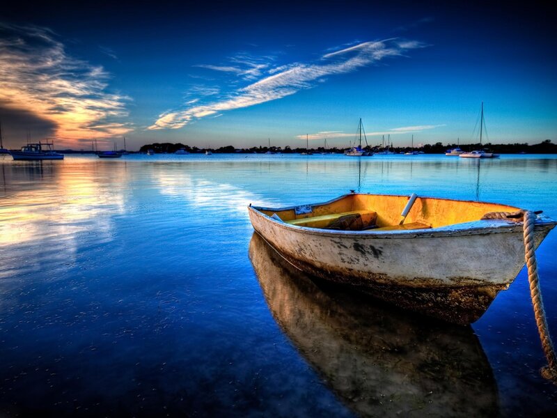 Boat at sunset on calm water