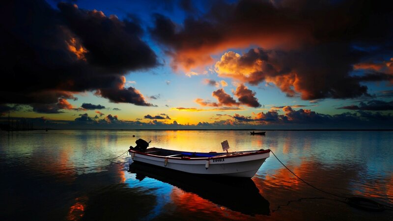 Boat at sunset on calm water