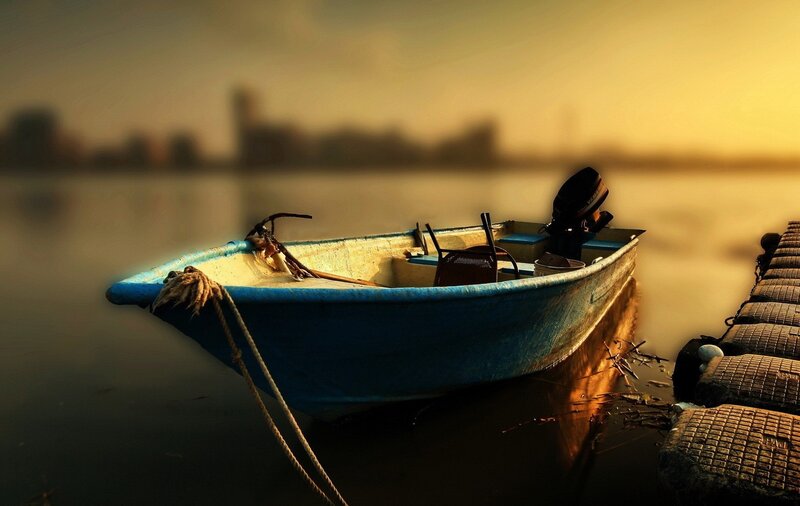 Boat at sunset on calm water