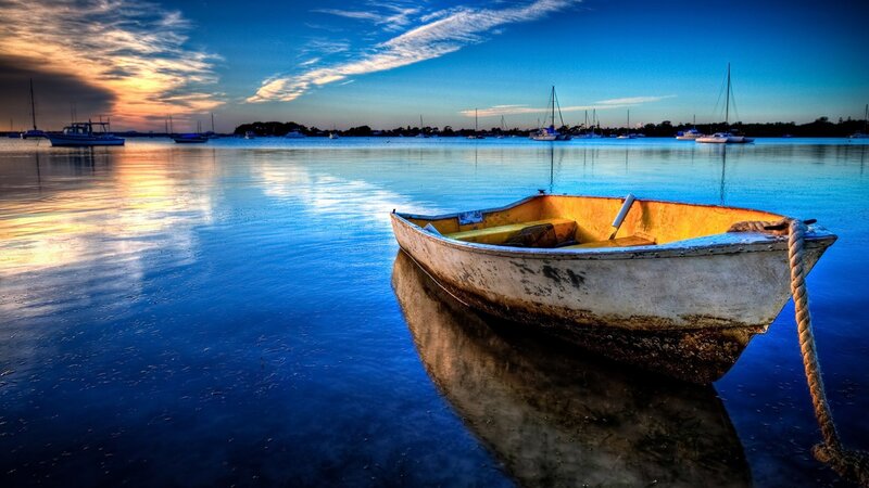 Boat at sunset on calm water