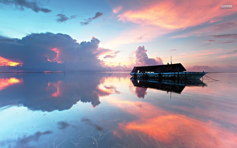 Boat at sunset on calm water