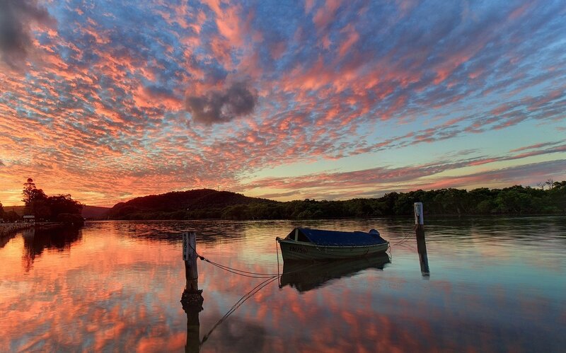 Boat at sunset on calm water