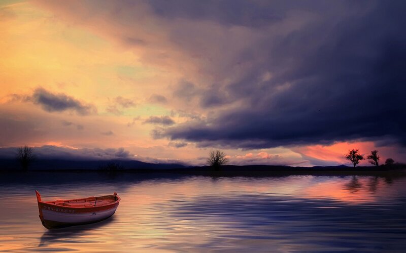 Boat at sunset on calm water
