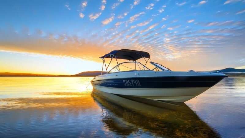 Boat at sunset on calm water