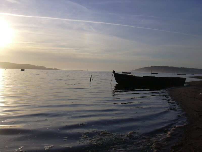 Boat at sunset on calm water