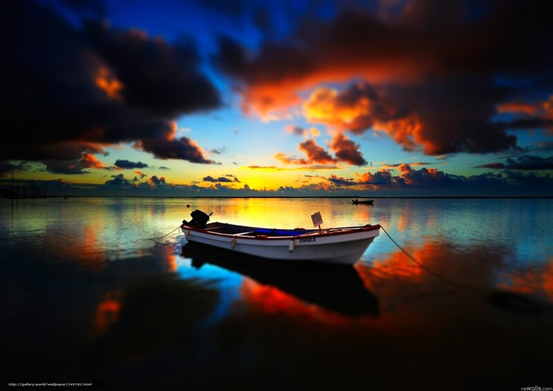 Boat at sunset on calm water