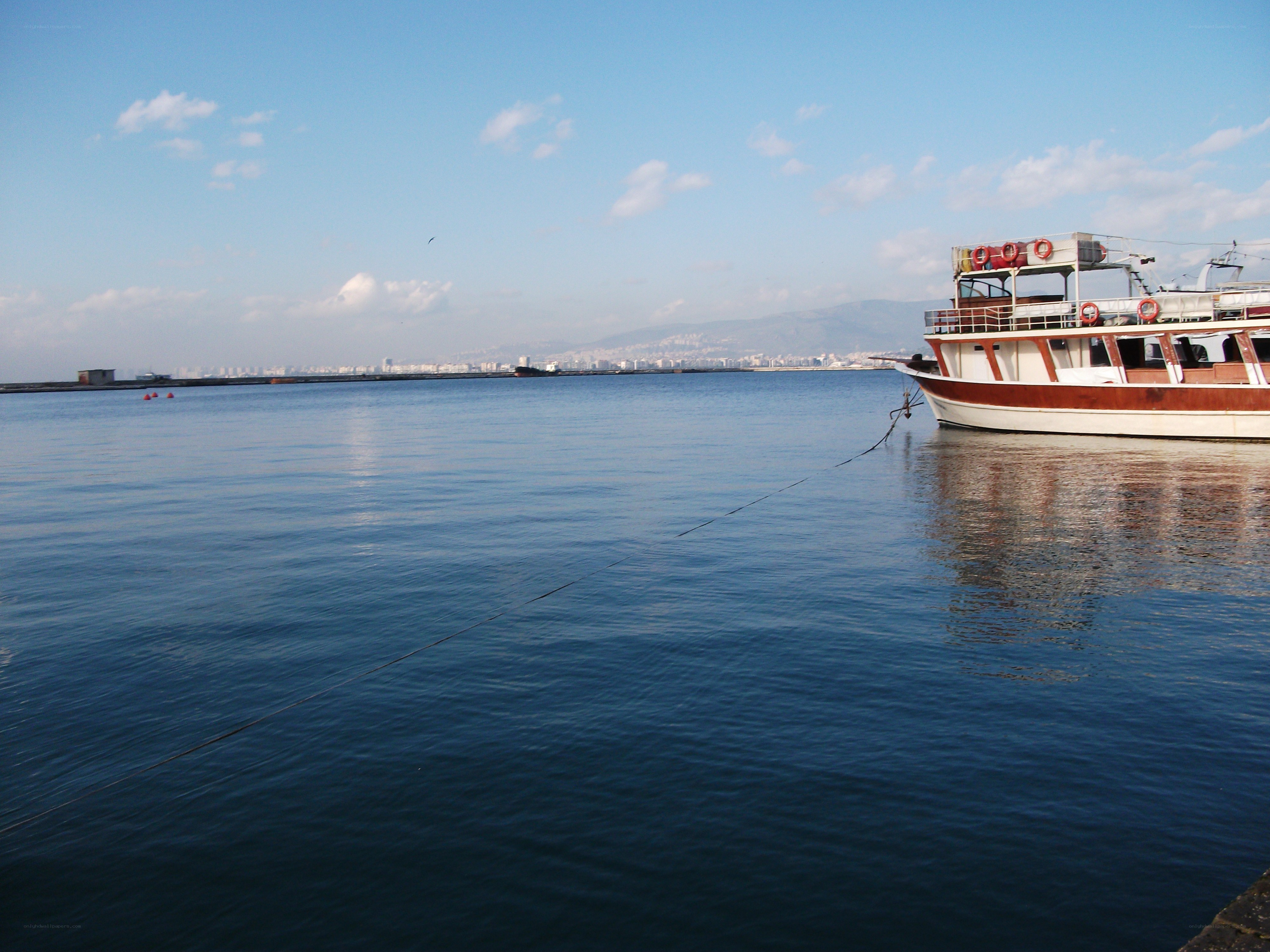 Boat docked in calm harbor
