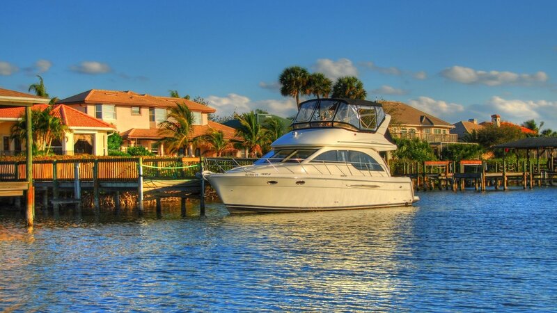 Boat docked in canal at sunset