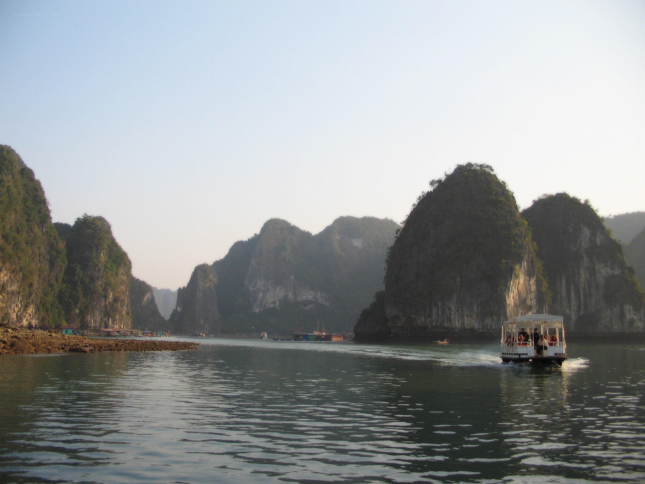 Boat in a bay with limestone cliffs