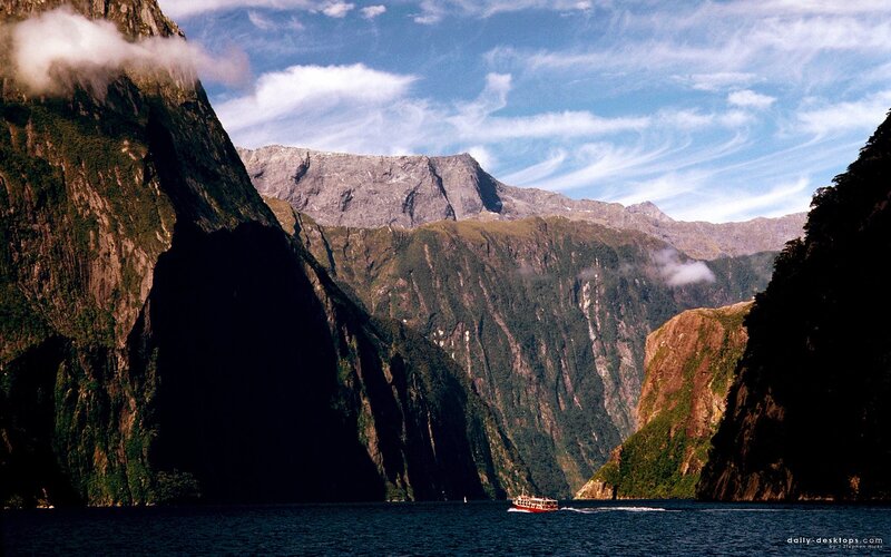 boat in a fjord with mountains