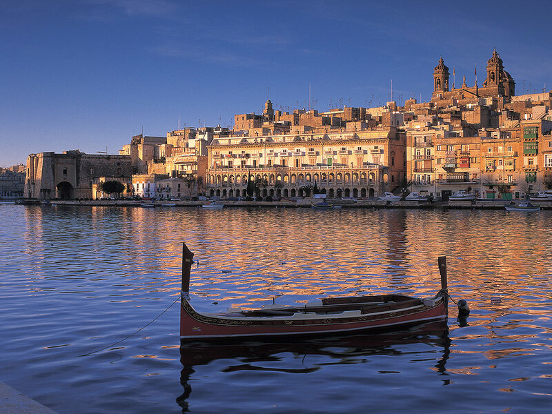 boat in a harbor at sunset