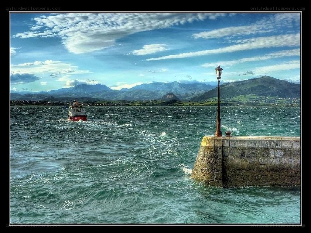 Boat in a harbor with mountains