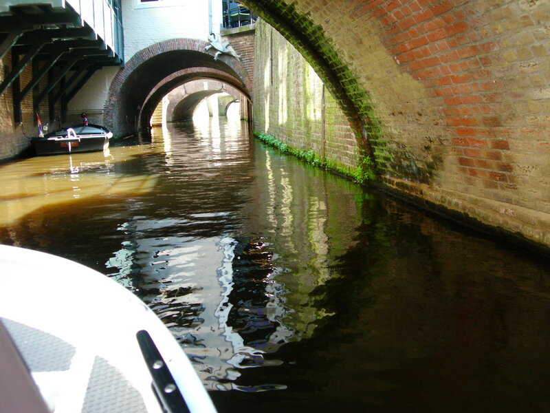 Boat in Canal under Arches