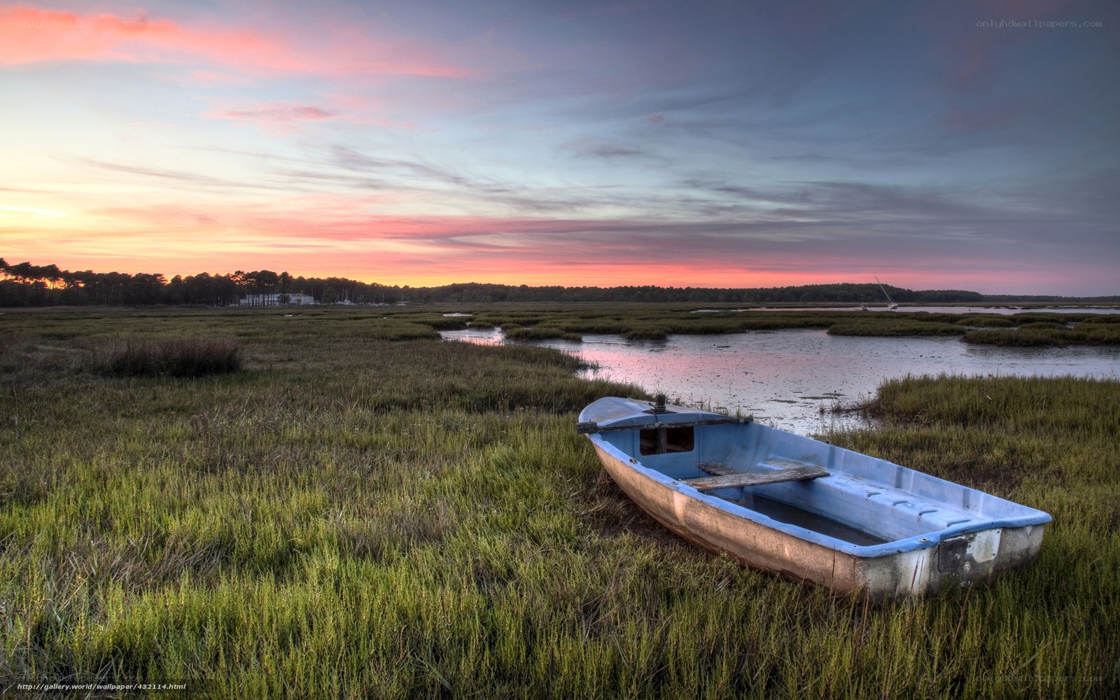 Boat in marsh at sunset