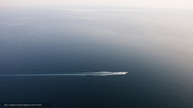 Boat leaving trail on calm sea