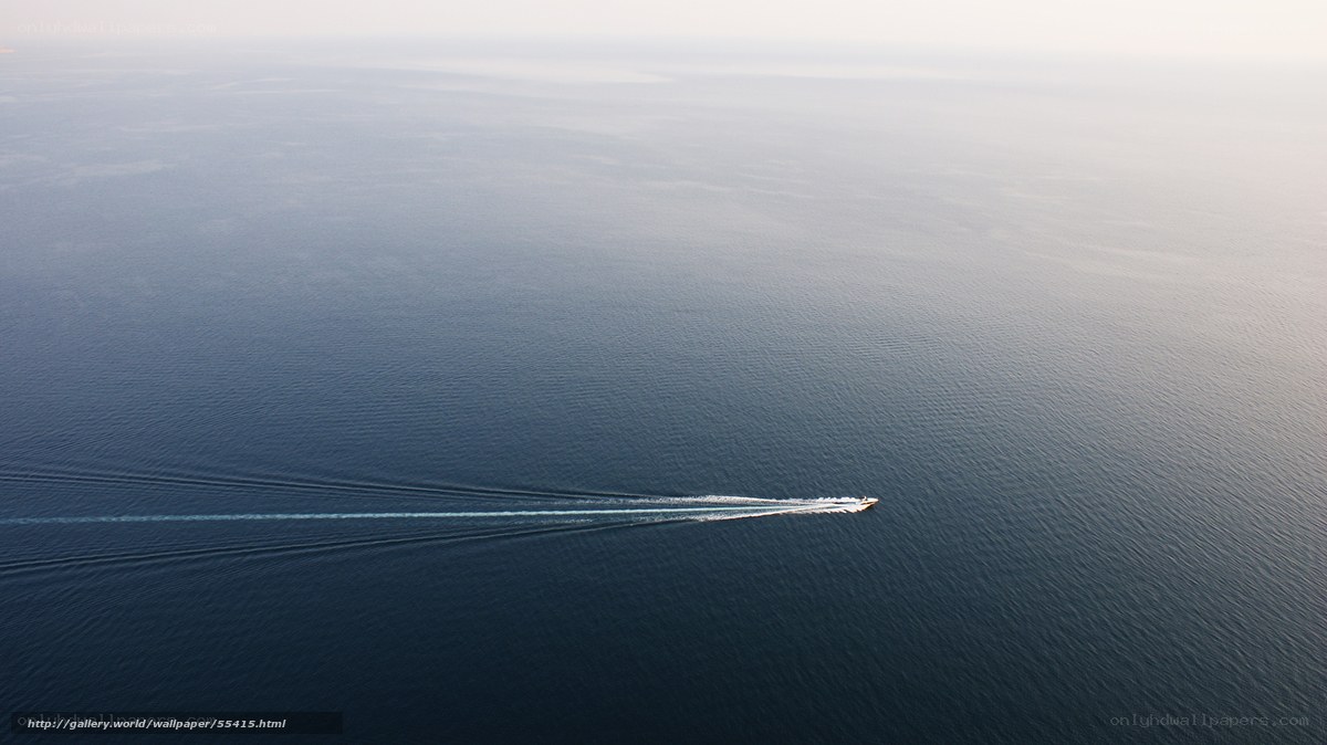 Boat leaving trail on calm sea
