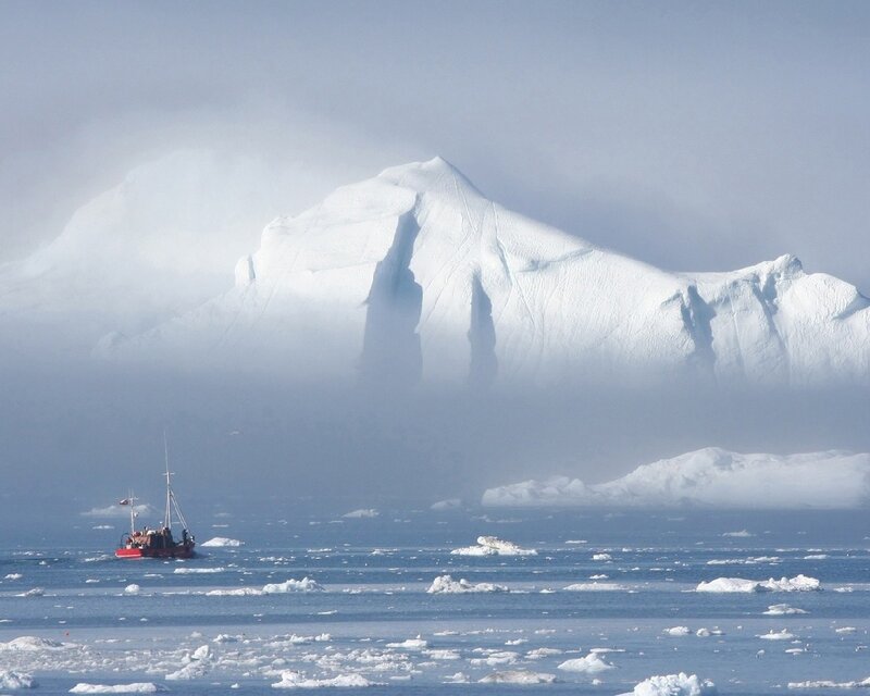 Boat near iceberg in fog