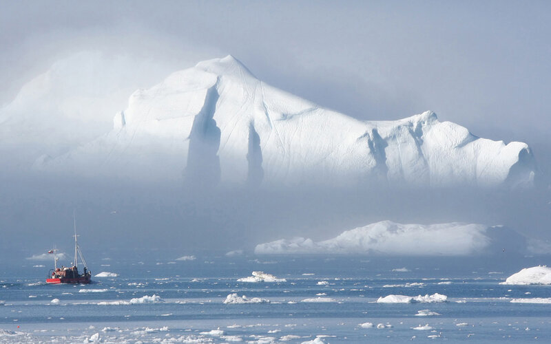 Boat near iceberg in fog