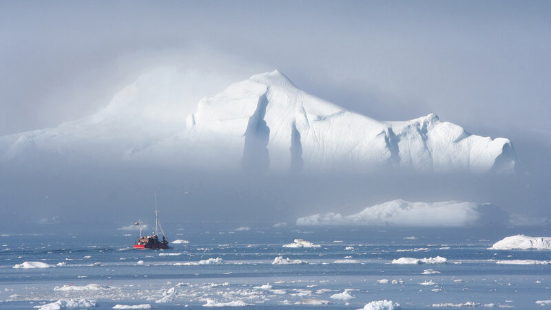 Boat near icebergs in Antarctica