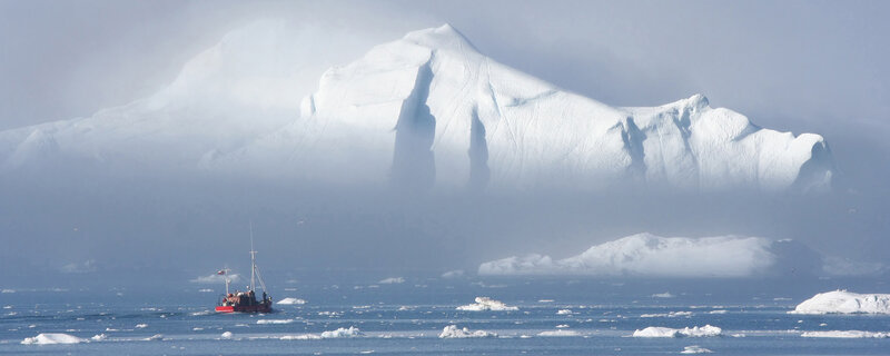 Boat near icebergs in fog