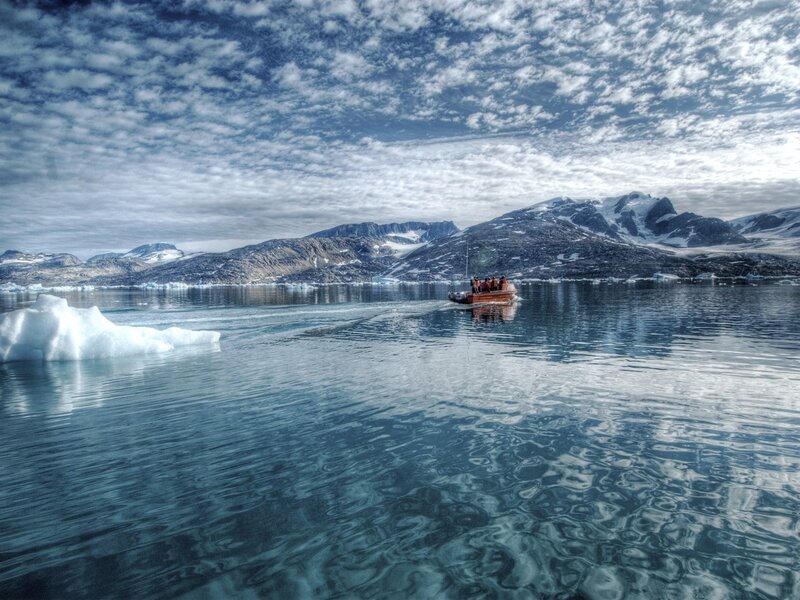 Boat near icebergs in Greenland