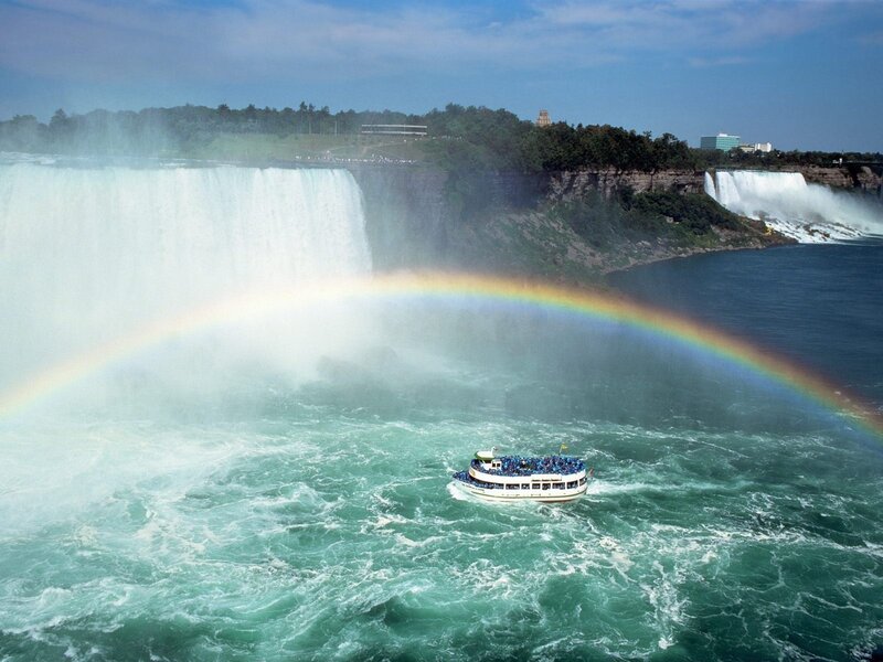 Boat near Niagara Falls with rainbow