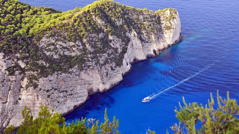 Boat Near Rocky Cliff — Blue